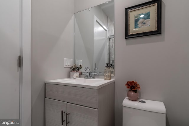 bathroom featuring toilet and vanity