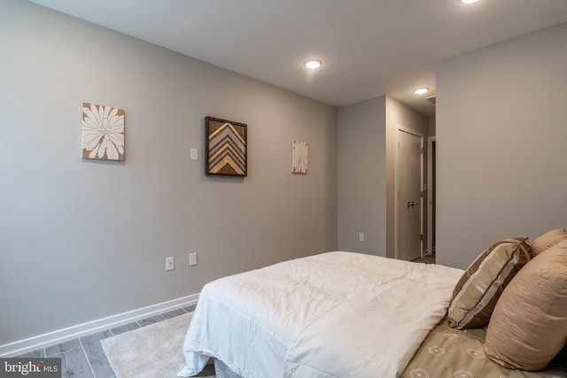 bedroom with recessed lighting, baseboards, and wood finished floors