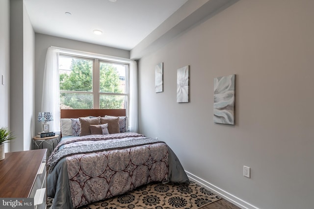 bedroom featuring baseboards and wood finished floors