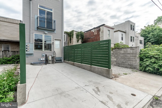 view of property exterior with cooling unit and a fenced front yard