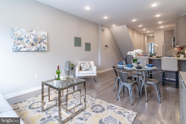 dining space with recessed lighting, visible vents, baseboards, and light wood-style floors