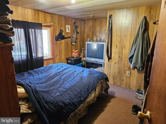 carpeted bedroom featuring wooden walls