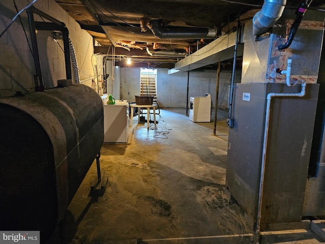 basement with heating fuel, heating unit, and independent washer and dryer