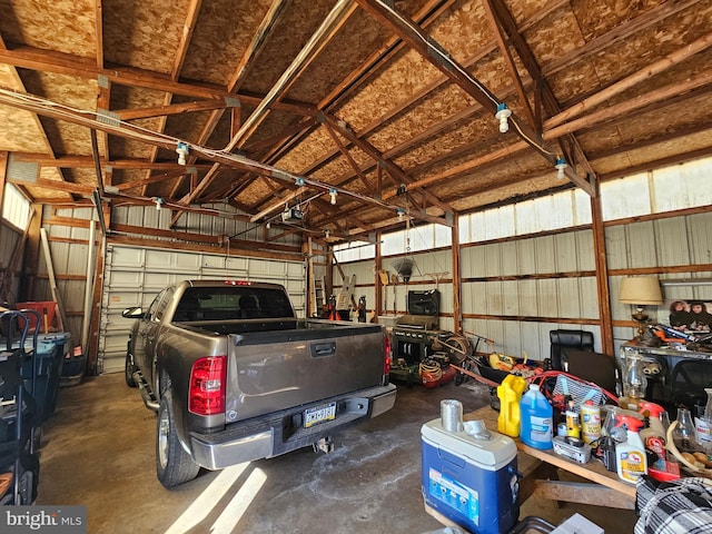 garage with a garage door opener and metal wall