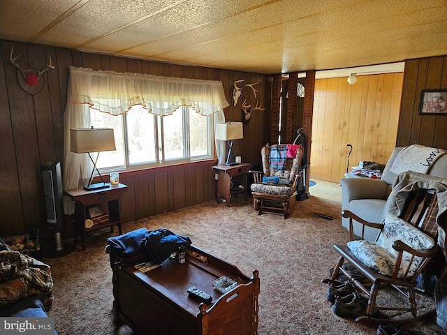 carpeted living room with wooden walls