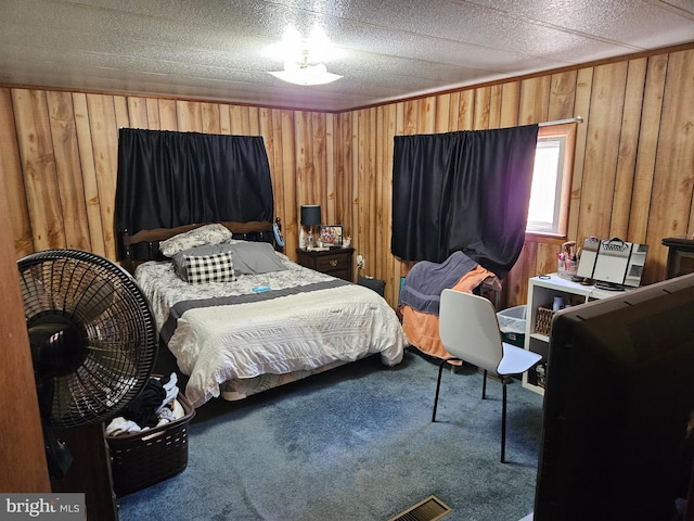 carpeted bedroom featuring wooden walls