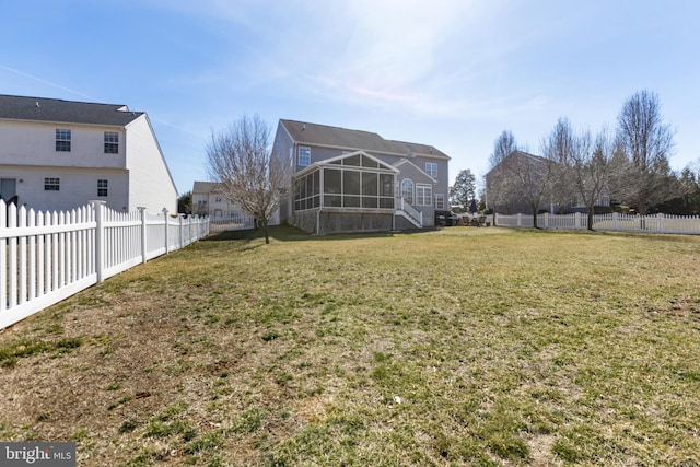 view of yard featuring a fenced backyard and a sunroom