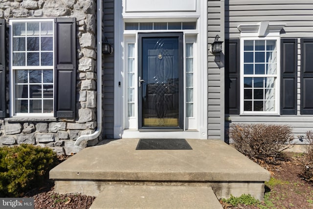 entrance to property featuring stone siding