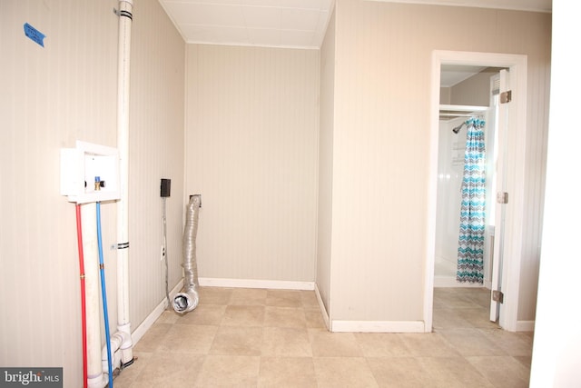 laundry area with baseboards