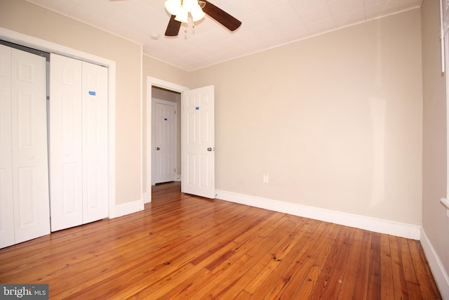 unfurnished bedroom with a closet, light wood-type flooring, and baseboards