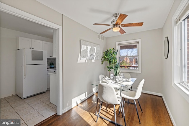 dining space featuring a ceiling fan, wood finished floors, baseboards, and visible vents