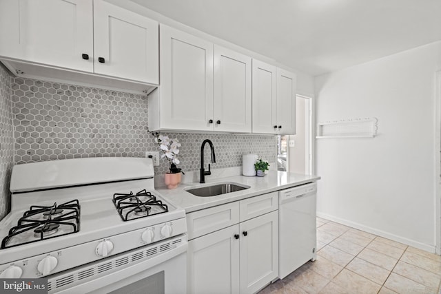 kitchen featuring tasteful backsplash, light countertops, white cabinets, white appliances, and a sink