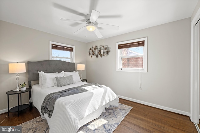 bedroom with ceiling fan, baseboards, and wood finished floors