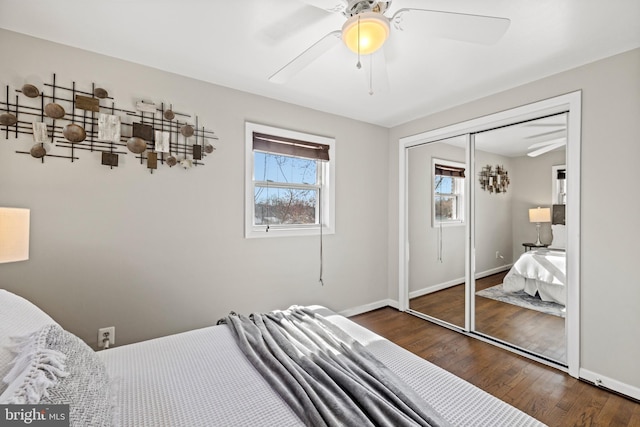 bedroom featuring ceiling fan, a closet, baseboards, and wood finished floors