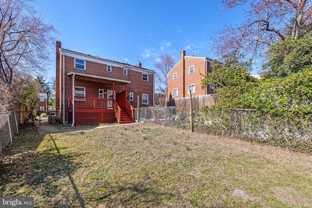 back of house featuring a yard, a fenced backyard, brick siding, and a chimney