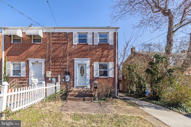 townhome / multi-family property with fence and brick siding