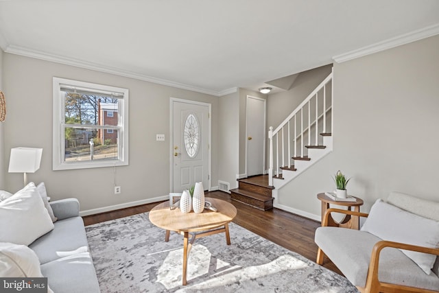 living room featuring stairs, wood finished floors, baseboards, and ornamental molding