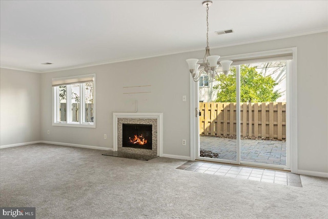 unfurnished living room featuring a chandelier, crown molding, baseboards, and carpet floors