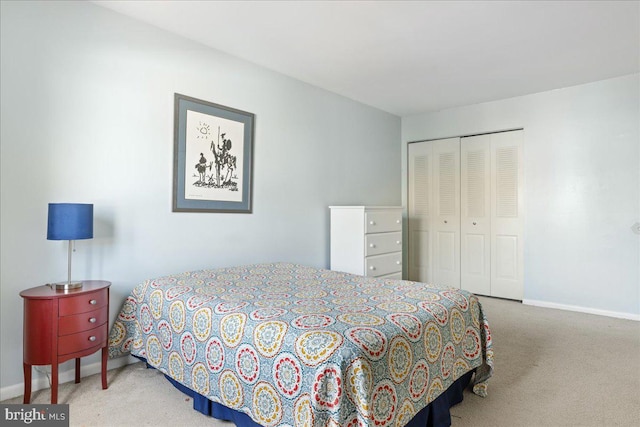 bedroom with a closet, baseboards, and carpet flooring