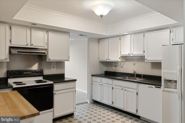 kitchen featuring white appliances, a sink, decorative backsplash, under cabinet range hood, and crown molding