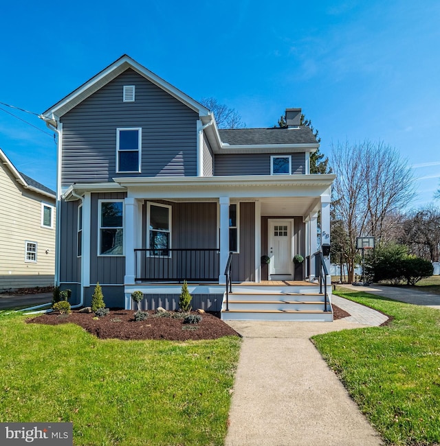 view of front of property featuring a porch, board and batten siding, and a front yard