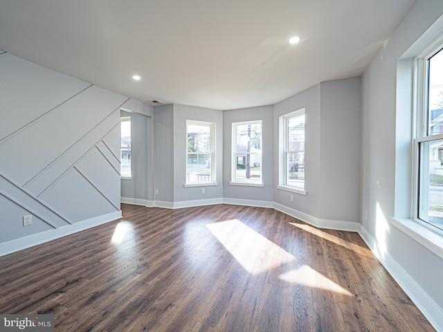 unfurnished living room featuring recessed lighting, visible vents, baseboards, and dark wood-style flooring