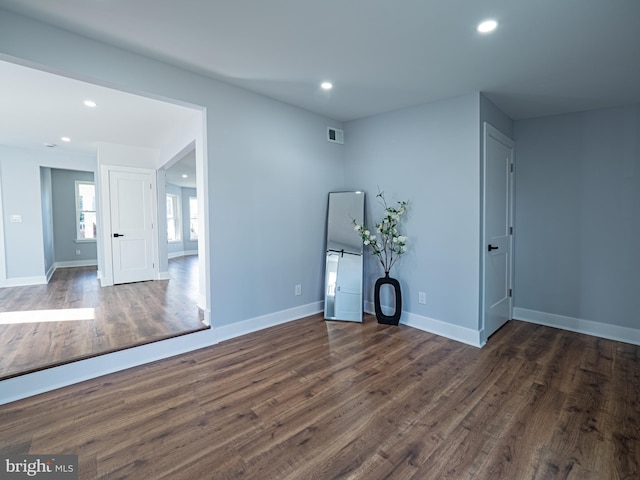 interior space with dark wood finished floors, visible vents, recessed lighting, and baseboards