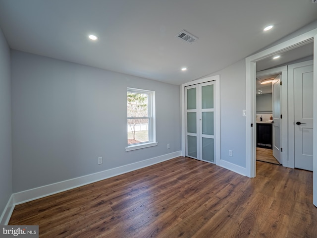 unfurnished bedroom with recessed lighting, dark wood-style floors, visible vents, and baseboards