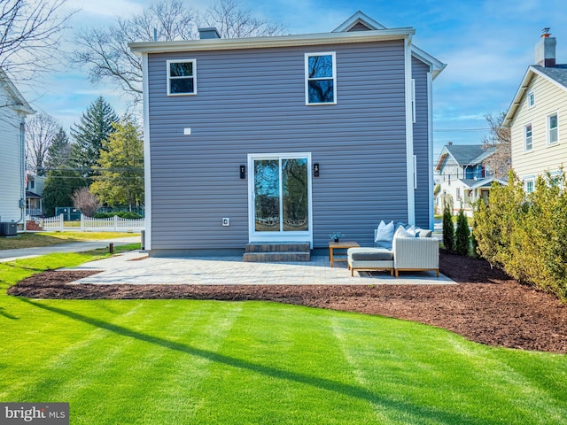 rear view of property with an outdoor living space, fence, a lawn, central AC unit, and a patio area