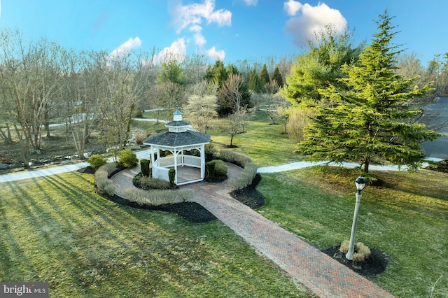 view of property's community with a gazebo and a yard