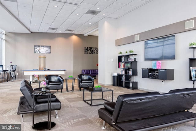 living area featuring carpet flooring, recessed lighting, baseboards, and a towering ceiling