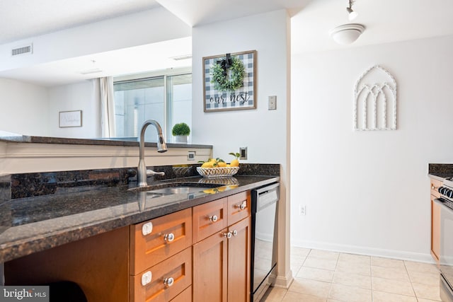 kitchen with dishwasher, dark stone counters, visible vents, and a sink