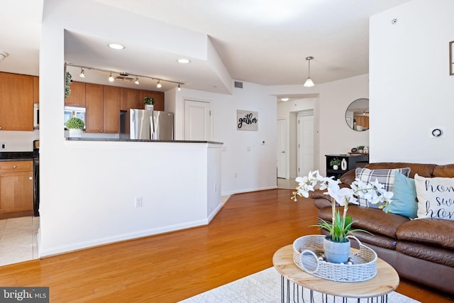 living room featuring baseboards and light wood-style flooring