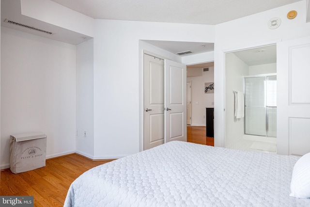 bedroom featuring baseboards, visible vents, and light wood-type flooring