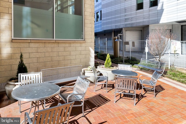 view of patio with outdoor dining area and fence