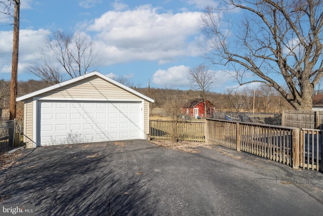 detached garage featuring fence