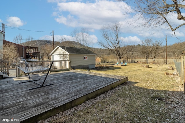 deck featuring an outbuilding and a lawn