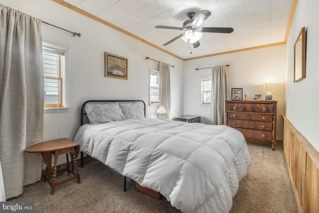 bedroom featuring ceiling fan, crown molding, and light carpet