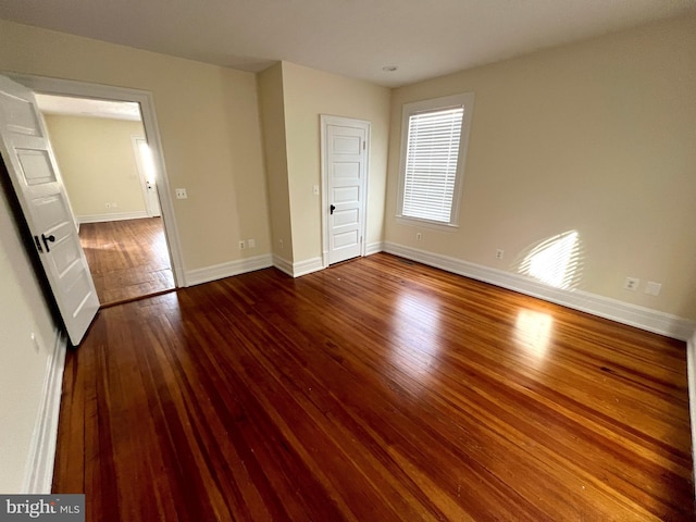 unfurnished bedroom featuring baseboards and hardwood / wood-style floors