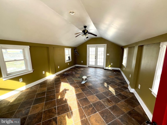 unfurnished living room featuring vaulted ceiling, french doors, baseboards, and ceiling fan