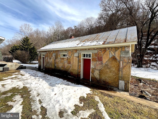 snow covered structure featuring an outdoor structure