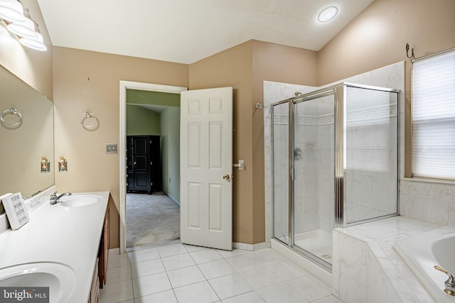 bathroom with a shower stall, a garden tub, a healthy amount of sunlight, and a sink