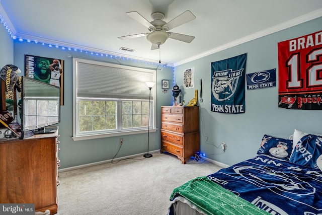 carpeted bedroom with ceiling fan, visible vents, baseboards, and ornamental molding