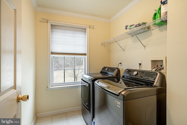 laundry area with baseboards, independent washer and dryer, ornamental molding, and laundry area