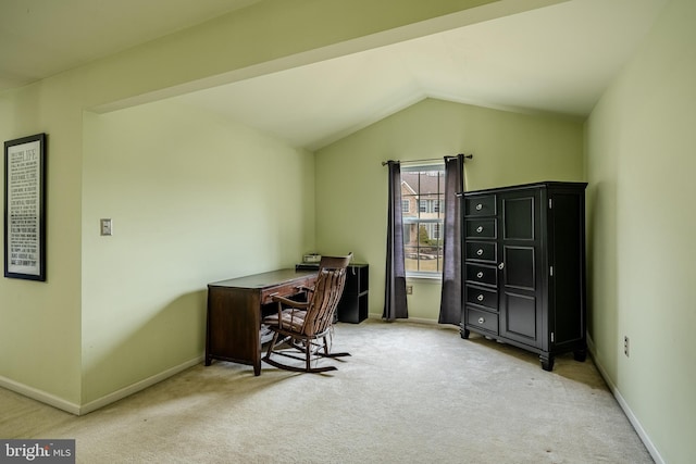 office area with lofted ceiling, baseboards, and light carpet