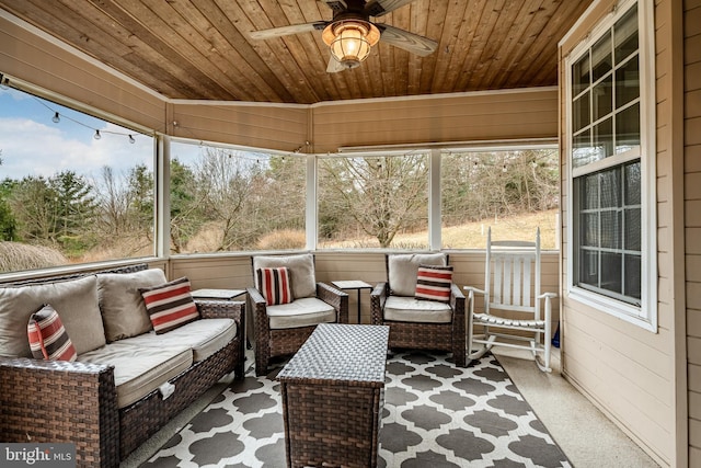 unfurnished sunroom with ceiling fan and wooden ceiling