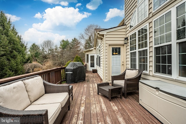 deck with area for grilling and an outdoor living space