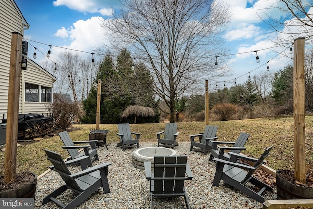 view of yard with a fire pit