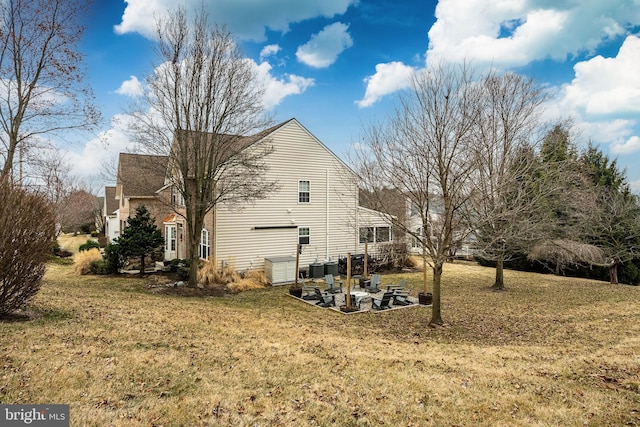 view of side of property with a lawn