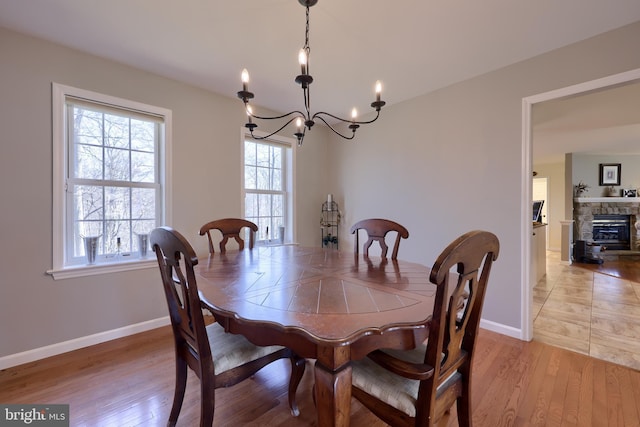 dining space with light wood-style flooring, a healthy amount of sunlight, and baseboards